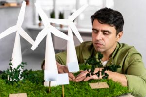 Man working on an eco-friendly wind power project with wind turbines