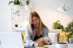 Medium shot woman working with dog indoors