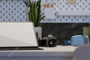 Modern hipster working desk with tablet mockup camera headphones and accessories on white table