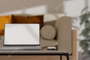 Notebook laptop and accessories on coffee table in comfortable minimal living room