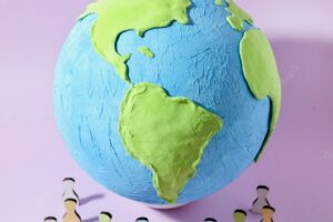 Paper style earth globe with silhouettes