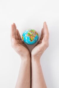 Person holding a globe on white background