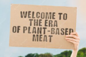 The phrase welcome to the era of plantbased meat on a banner in hand nutrition food