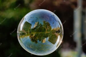 Soft focus of a bubble with reflection of city buildings and trees on it