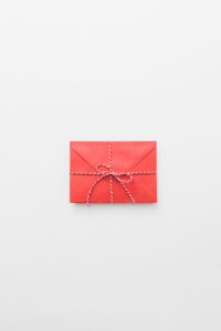 Tied red envelope on table