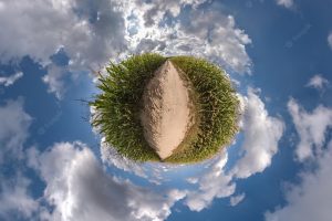 Tiny planet transformation of spherical panorama 360 degrees spherical abstract aerial view in field with clear sky and awesome beautiful clouds curvature of space