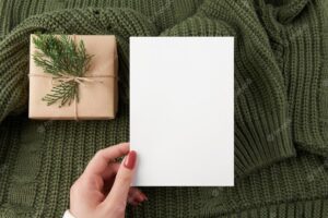 Vertical card mockup with green knitted sweater background 5x7 intivation template