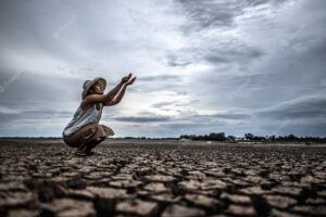 A woman is sitting asking for rain in the dry season, global warming