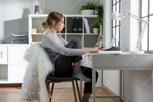 Woman sitting on chair at desk