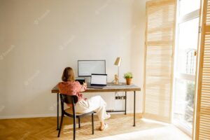 Woman works online on computers at home