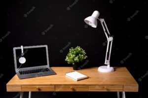 Wood desk with laptop and lamp