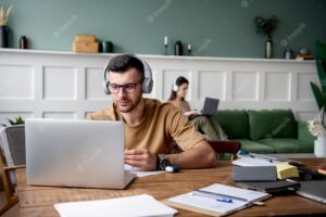 Young man listening to music during study session