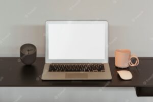 Blank laptop screen and a pink coffee cup