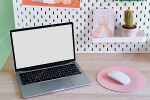 High angle of children's desk with laptop and mouse