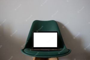 Laptop with blank screen on chair