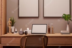 Minimalist home workspace with wood furnitures laptop and decor on wood table against wall
