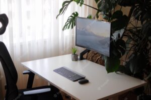 Modern home office with curved screen and orthopaedic chair. interior with plants