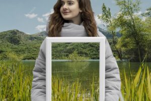 Person holding frame with open nature landscape concept