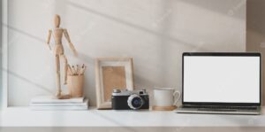 Photographer creative studio with blank screen laptop and office accessories