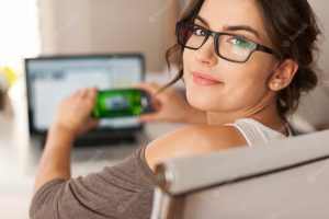 Smiling woman paying bills by scanning qr code