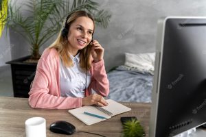 Woman with headset working on computer