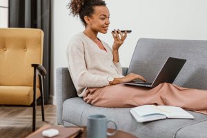 Woman working while sitting on the sofa