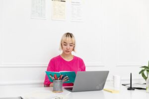 Young woman working from home on her laptop
